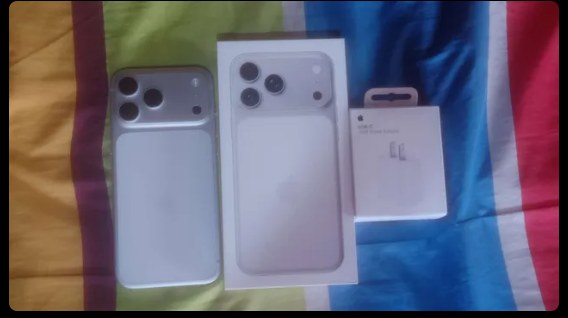 A boxed iPhone 17 Pro Max on a bed